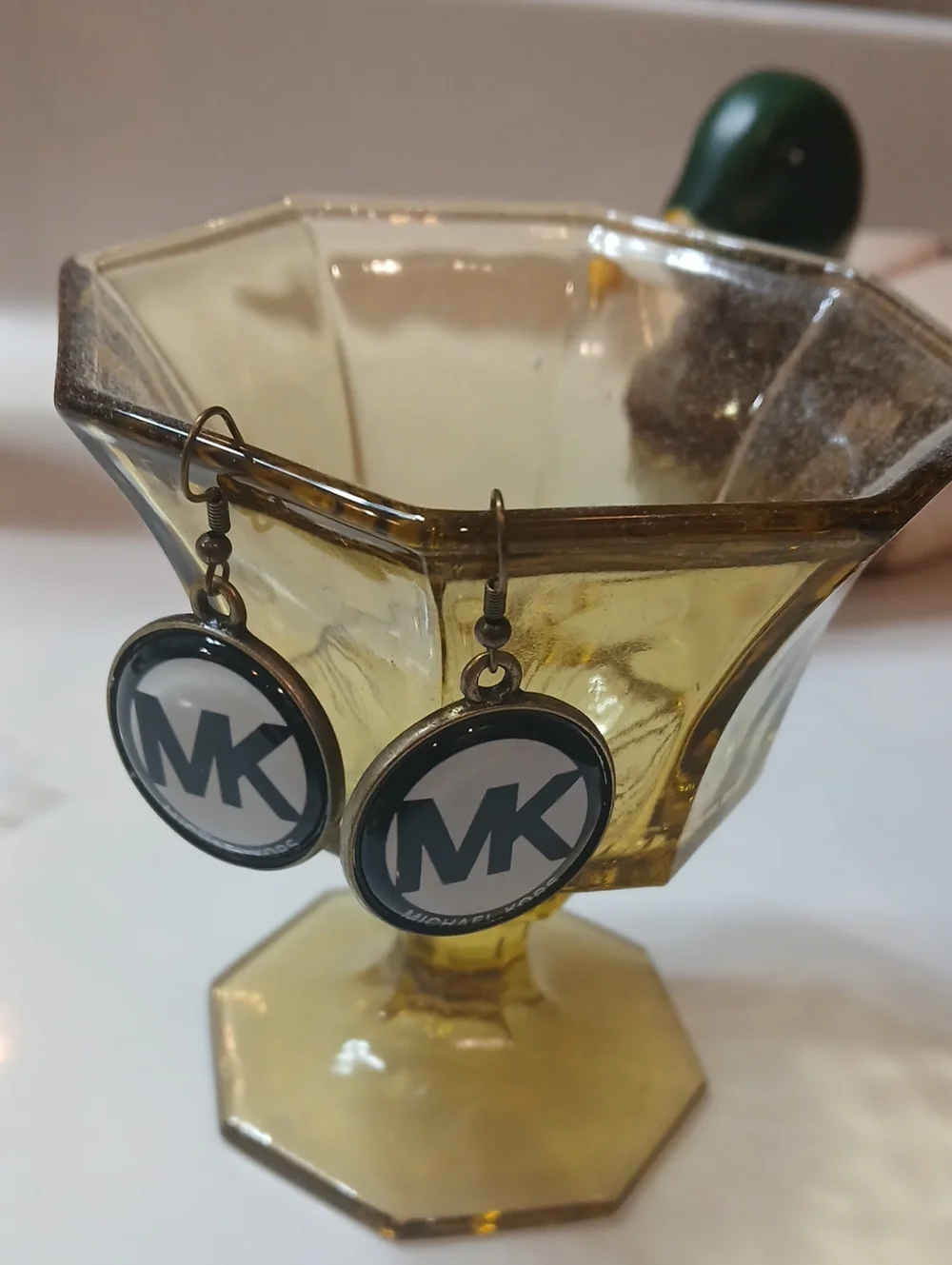 Michael Kors round logo dangle earrings feature the brand's iconic 